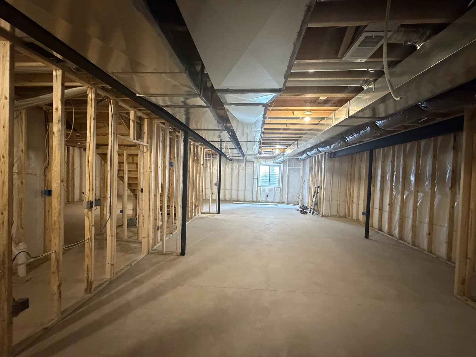Basement wall framing with steel beam and duct soffit runs, Troy MI