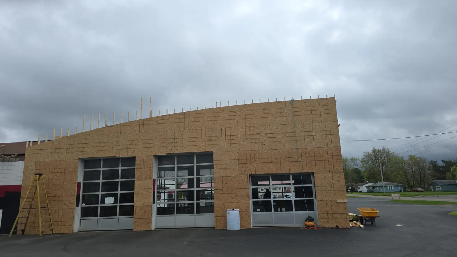 Commercial service building framed and sheathed, overhead door openings rough-framed