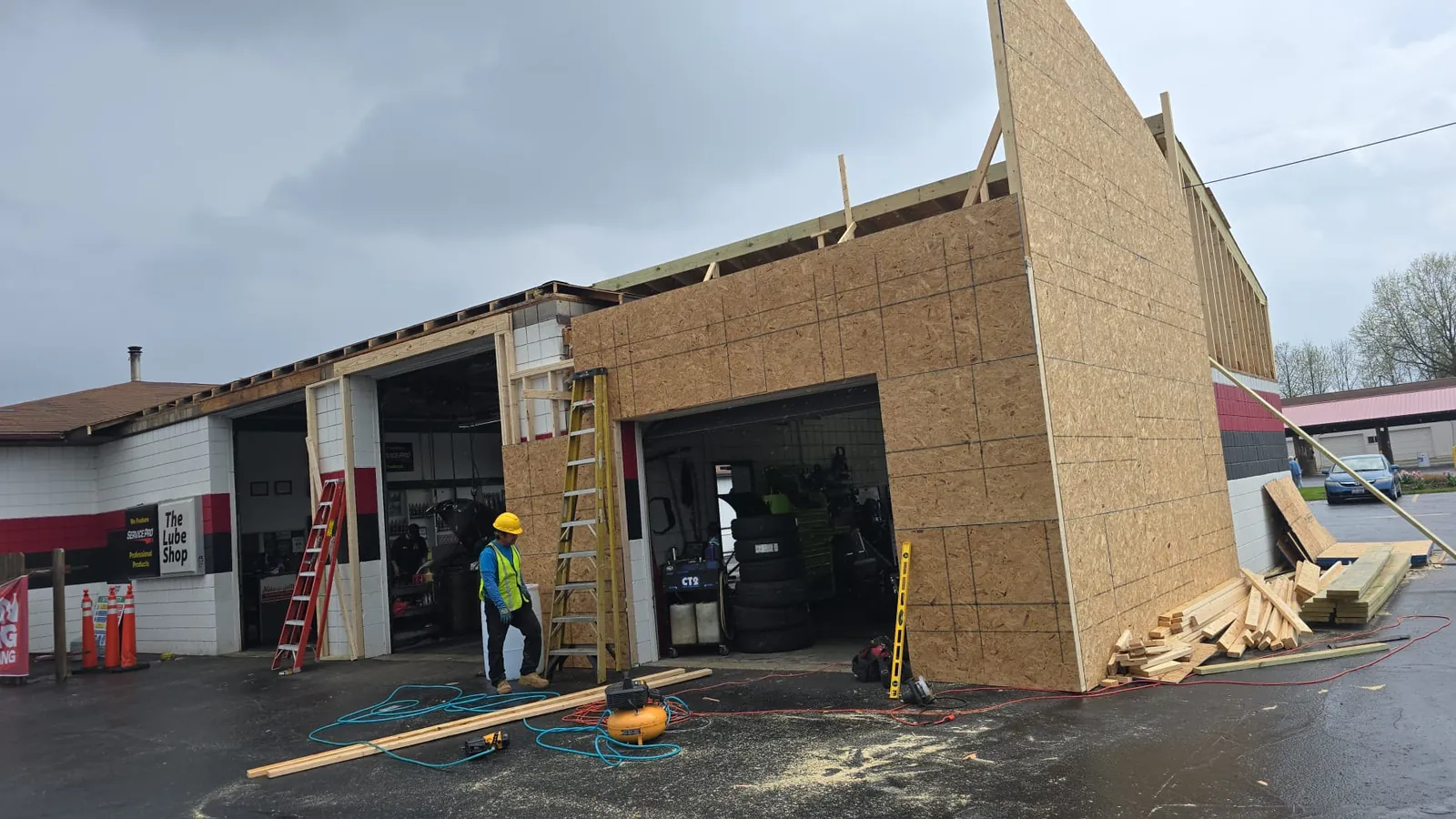 Crew standing a sheathed wall section on a commercial addition