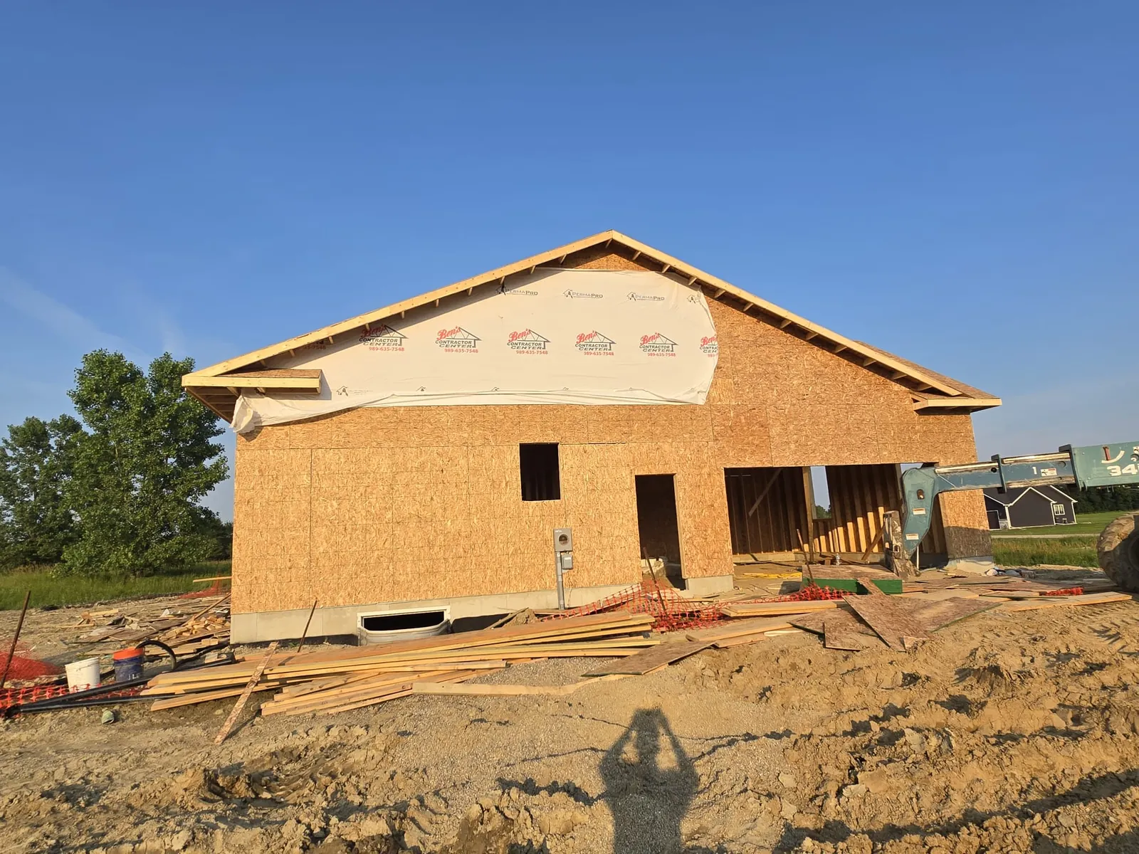 Rough framing complete on a new single-story home at sunset, Genesee County MI